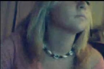 Blonde shows herself in front of a webcam