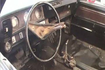 A girl shows off her breasts in a car dealership