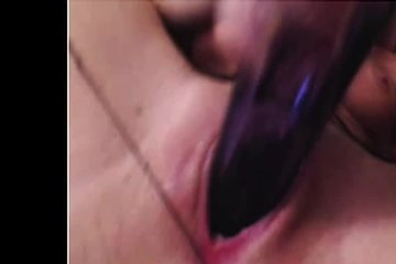 Brunette fingering her clitoris with a vibrator at her leisure