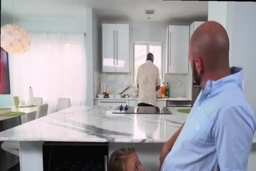 The man gives his chick under the table in his mouth while chatting with her father