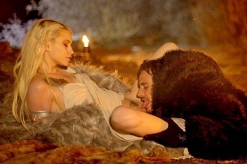 A pussy in a fur coat has fun with a beautiful blonde in the night forest