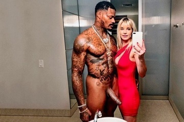 A negro fucks a blonde with silicone tits with a big dick in a hotel